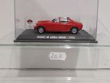 an old model of a red sports car in a glass display case