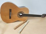 a guitar, flute, and recorder on a table