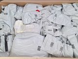 a cardboard box full of white shirts in it
