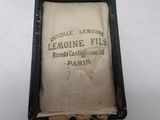 an old book sitting on top of a wooden table next to a pair of scissors