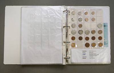 a close up of a book with a bunch of coins in it