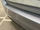 a close up of a car ' s front bumper with scratches on it