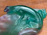 a close up of a green glass object on a table