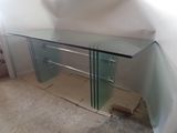 an image of a glass desk in a corner of a room