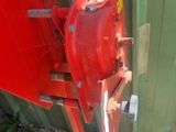 a red fire hydrant attached to the side of a green building