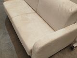 a white couch that is sitting on the floor