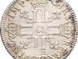a close up of a coin with a cross on it