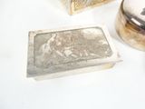a silver box sitting next to a silver box on a table