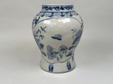 a blue and white vase sitting on a white surface