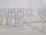 quatre verres à vin sont alignés sur une surface blanche