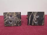 pair of black and white marble cufflinks on a red cloth