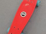 a red skateboard laying on the ground on the ground