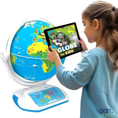 une petite fille qui tient une tablette devant un globe terrestre