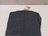 the shirt is folded up on a white surface with a tag on it