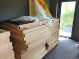 many stacks of wood stacked on top of each other in a room