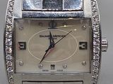 an image of a close up of a wrist watch with diamonds on it