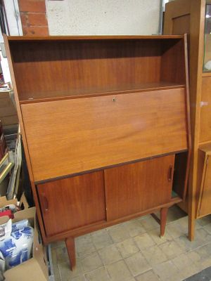 a wooden cabinet with a mirror on top of it