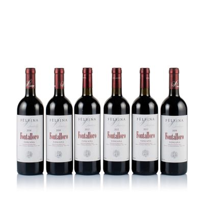 four bottles of red wine are lined up on a white surface