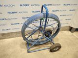 an image of a blue hose cart with wheels in a room