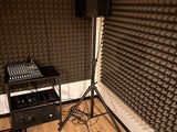 a sound booth with speakers and a mixer in the corner
