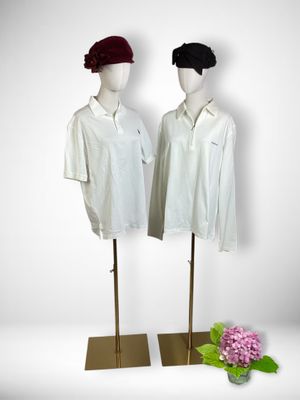 pair of mannequins wearing white shirts and red berets