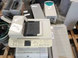 a pile of electronic equipment on a pallet in a warehouse