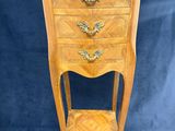 a wooden chest of drawers with a shelf on top of it