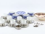 de nombreuses tasses, soucoupes et cuillères sur la table