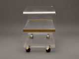 two clear acrylic boxes with gold handles on wheels