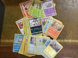 a pile of pokemon cards sitting on the floor
