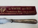 a knife that is sitting next to a box on a table