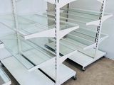 many shelves with glass shelves on them in a room