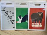 three bags with pictures of animals on them on a table