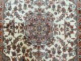 an antique persian rug with a floral design on a white ground