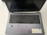 an open laptop computer sitting on top of a white table