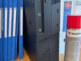a desktop computer sitting on a desk next to a can of paint