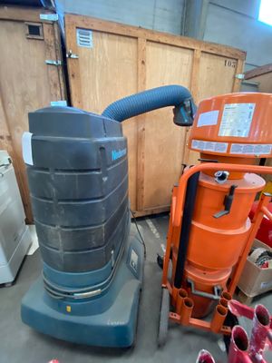a machine that is sitting next to a pile of trash