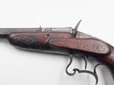 an old gun that is on display on a white surface