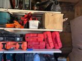 many different tools on a shelf in a garage