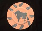 a plate with a picture of a bull on it