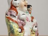 a ceramic figurine of a man and two children