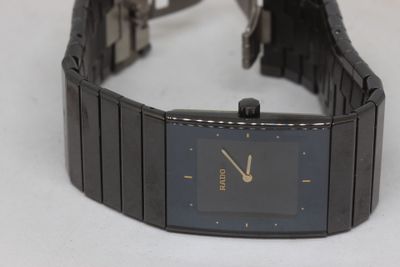 a watch that is sitting on a white surface
