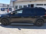 a black suv that is parked in front of a building