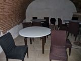 many chairs and tables in a room with a brick wall