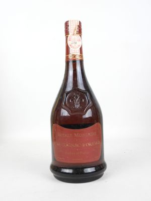 an old bottle of wine sitting on top of a white table