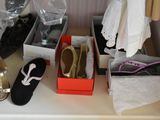 many pairs of shoes that are sitting on a shelf