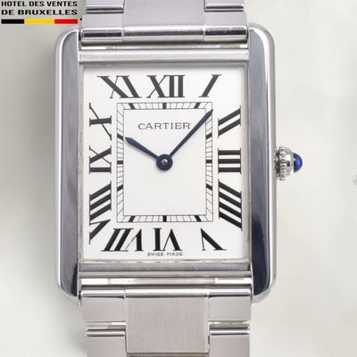 a silver watch with roman numerals on the face