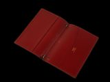 red leather wallet on a black background with a black background