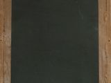 a chalk board on the wall next to a window