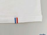 a white t - shirt with a red, white and blue stripe on it